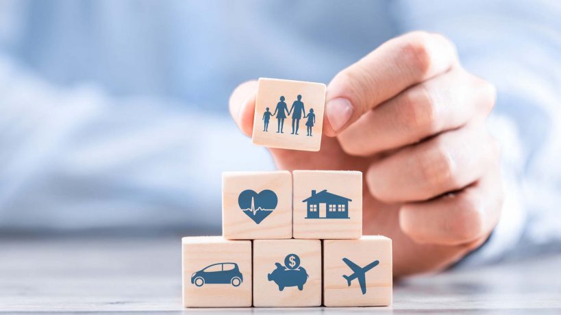 Wooden blocks with icons of various types of insurance. Life insurance concept.